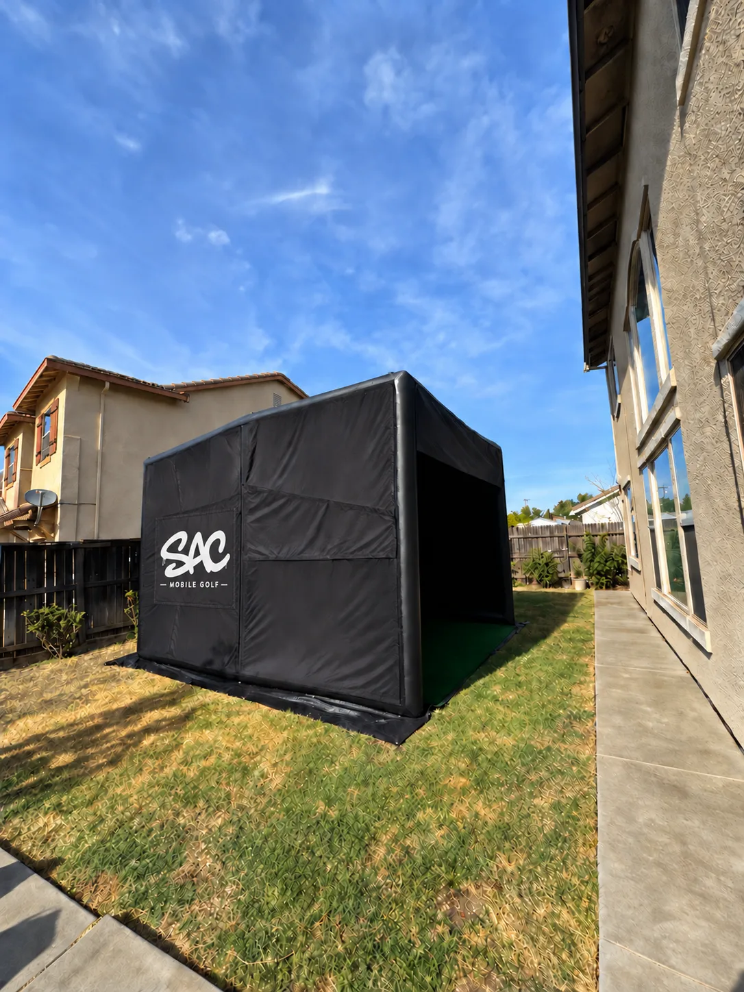 Sac Mobile Golf simulator set up in a residential backyard